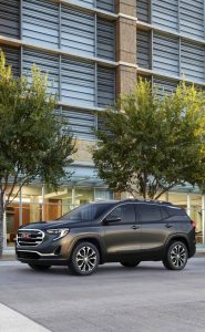 A GMC vehicle parked on a residential street.