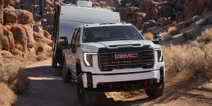 A 2025 GMC Sierra 2500 HD driving through a canyon road.